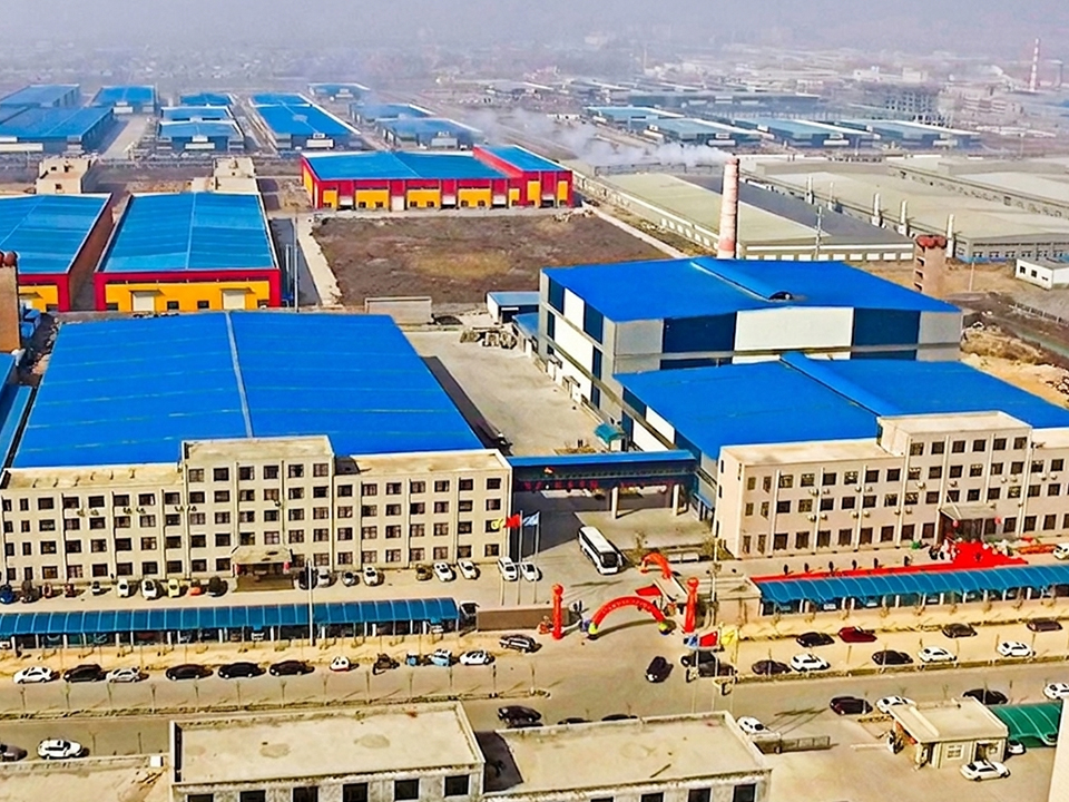 Aerial view of Hualian Glass large-scale glass packaging manufacturing facility with blue-roof production warehouses